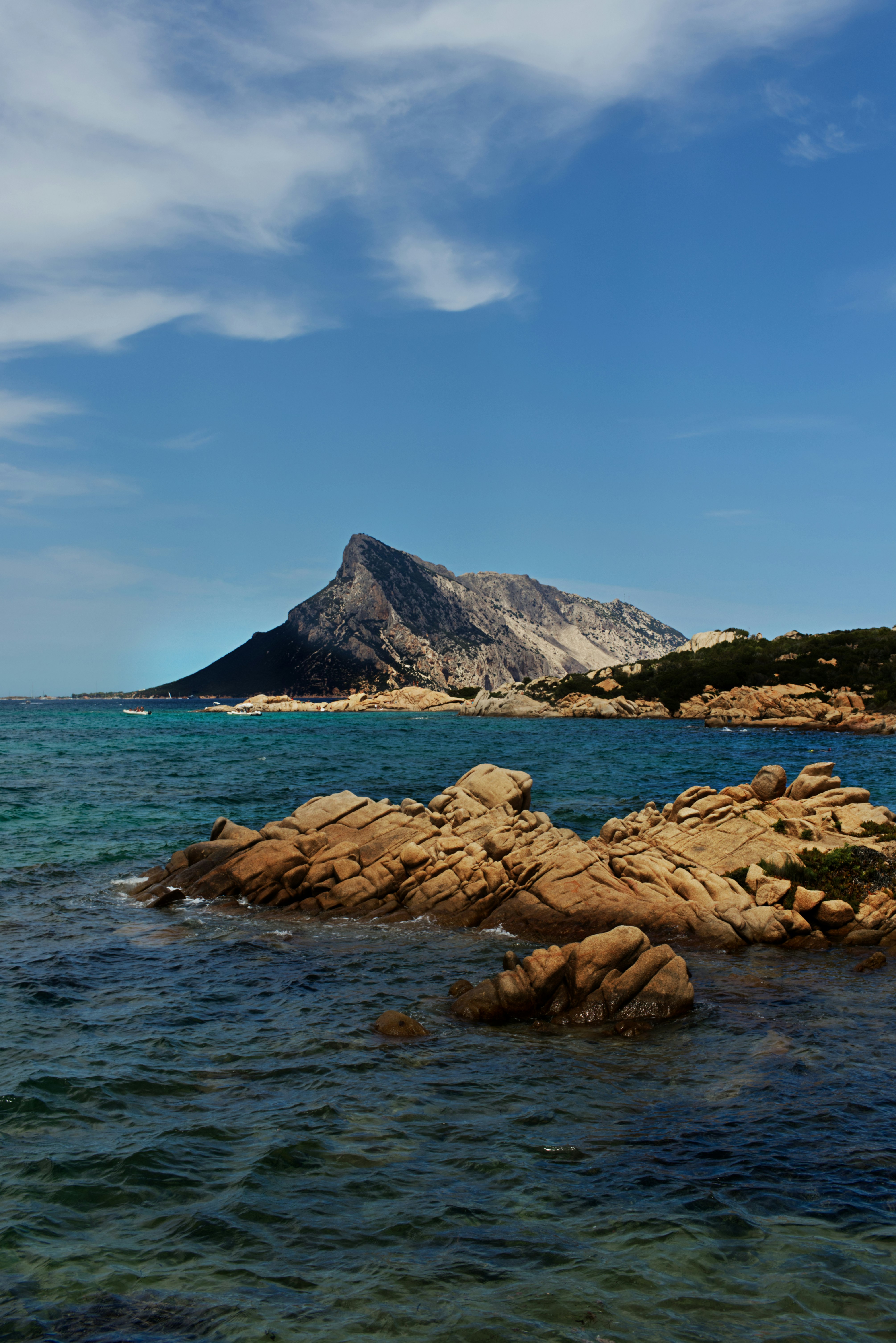 brown rocks on sea shore during daytime